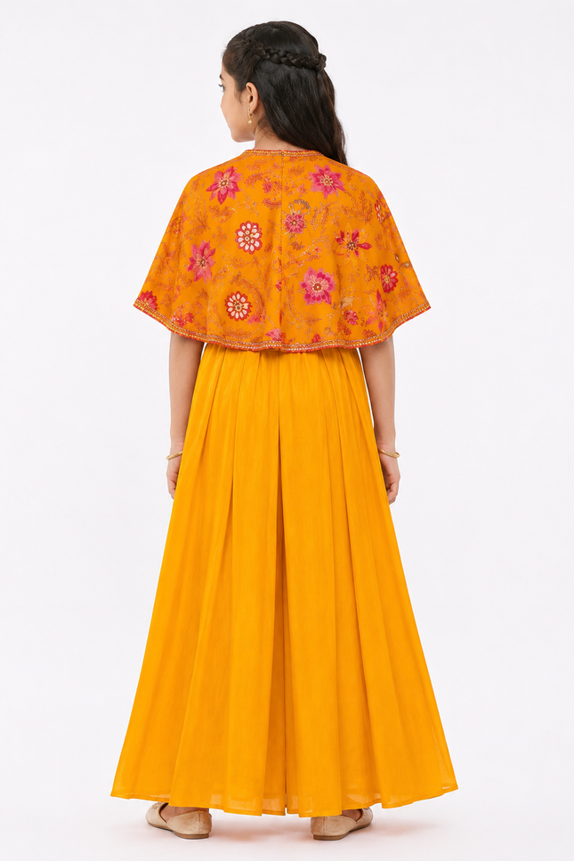 cape-style top paired with flowy wide-leg palazzo pants