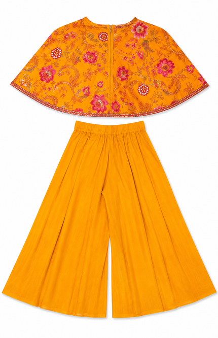 cape-style top paired with flowy wide-leg palazzo pants