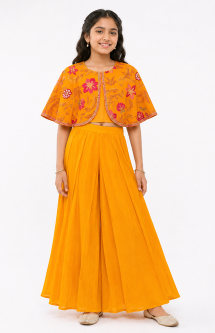 cape-style top paired with flowy wide-leg palazzo pants