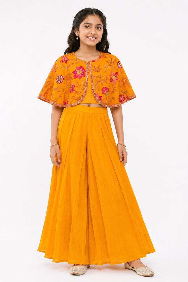cape-style top paired with flowy wide-leg palazzo pants